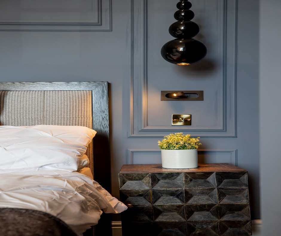Interior architecture of a bedroom with side table and some accessories