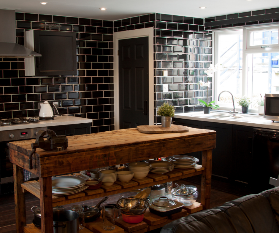 Rustic-modern kitchen with open shelving. The dark black backsplash pops against the butcher block island and white countertops.